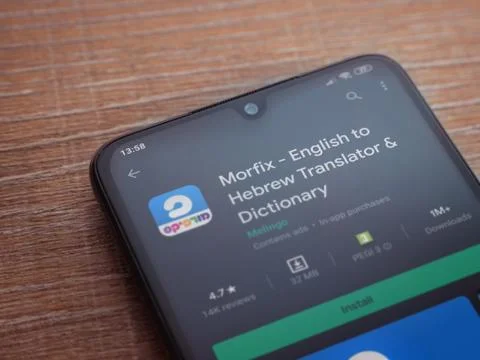 Morfix app play store page on the display of a black mobile smartphone on woo Stock Photos