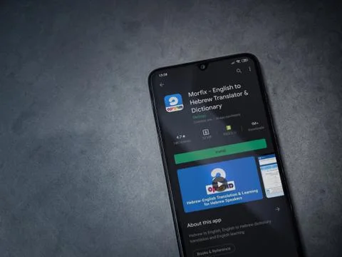 Morfix app play store page on the display of a black mobile smartphone on a d Stock Photos