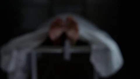 Morgue   rack focus to spooky toe tag swaying slowly on dead corpse foot Stock Footage 72752573