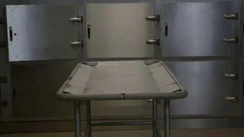 Morgue   tilt down from compartments to gurney Stock-Footage 72968759