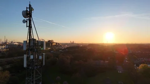 Morning backlit telecom tower over industrial corridor Video stock 331206676
