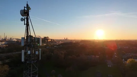 Morning backlit telecom tower over industrial corridor Stock Footage 340925581