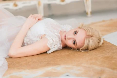 Morning of a beautiful young bride in a boudoir dress. Stock Photos
