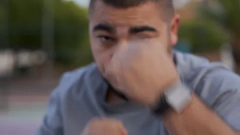 Morning Boxing Session: Guy Throws Powerful Punches in Shadowboxing on Palm Stock Footage 243170161
