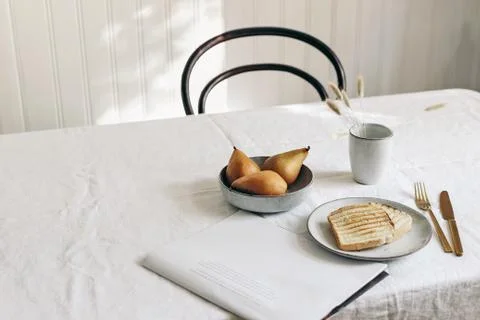 Morning breakfast with pears fruit composition. Bread toast, folded newspapers Stock Photos