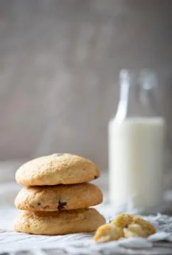 Morning Chocolate chip cookies with milk in bottle on table. Stock Photos