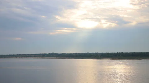Morning cloudy sky over the river, the sun's rays break through the clouds, the  Stock Footage 113116039