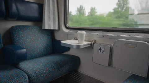 Morning coffee cup on a table inside a moving train Stock Footage 332276408