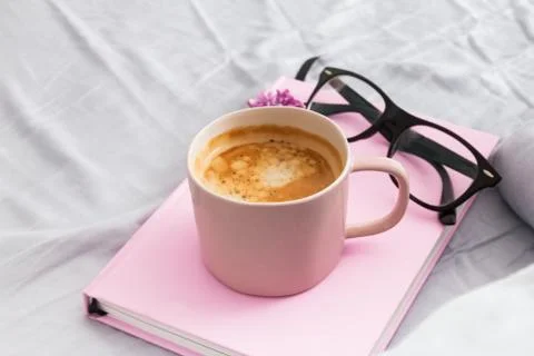 Morning composition with coffee, pink notepad or diary and glasses Stock Photos