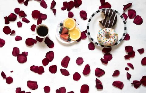 Morning Cup of coffee, empty notebook and roses flowers, fruits and donuts on Stock Photos