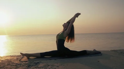 Morning exercise. Twine. Yoga mat woman stretching hip, hamstring muscles and Stock Footage