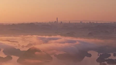 The morning light is covered with clouds and waves, and the tall buildings loom. Stock Footage 311725136