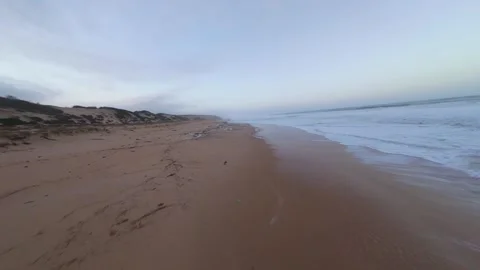 Morning light illuminates beach as waves break gently. After the storm Stock Footage 345148775