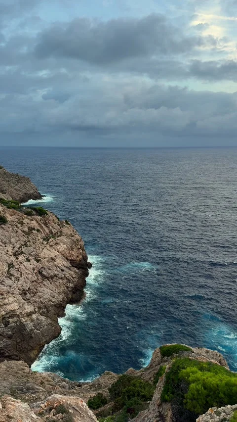 Morning light illuminates Capdepera Lighthouse on rocky coast of Mallorca. Stock Footage 340322343