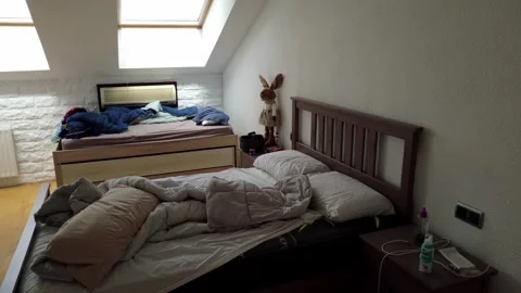 Morning Light Shining Through Skylight onto Unmade Bed Stock Footage 310017597