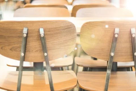 Morning light through rows of  Empty table and chairs in cafe restaurant Stock Photos