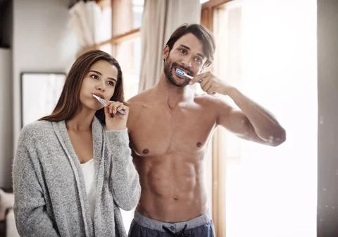 Morning minty freshness. a young couple brushing their teeth together at h... Stock Photos