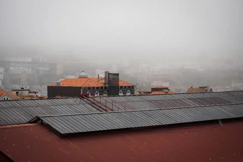 Morning mist over the rooftops of central Porto Stock Photos