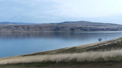 Morning panorama of a lake surrounded by hills Stock Footage 260535853