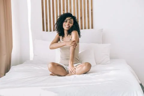 Morning positive mood. Young african woman wake up and smiling. Body positive Stock Photos
