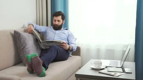Morning reading of the fresh press. Casual style and funny socks Stock Footage