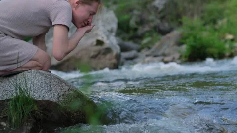 Morning refreshment in the clear cold stream. Stock Footage 313608660