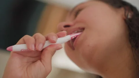 Morning routine captured with energetic tooth brushing at hotel sink. Closeup of Stock Footage 334074594