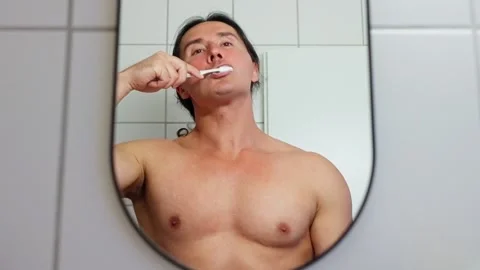 Morning Routine Engaging in Brushing Teeth in the Mirror for Exceptional Oral Stock Footage 316542514