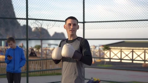 Morning Shadowboxing: Guy's Dynamic Routine on Palm-Embraced Basketball Court Stock Footage 243170462