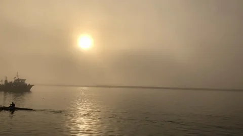 Morning Sun and Mist with Fishing Boat and Kayak Stock Footage