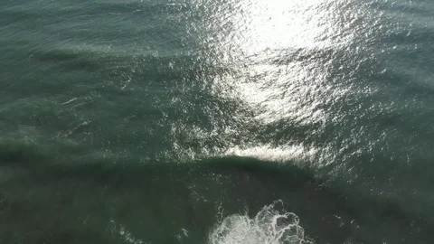 Morning sun is reflected in the waves of the ocean. Aerial drone footage Stock Footage 97264678