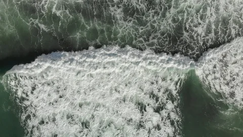 Morning sun is reflected in the waves of the ocean. Aerial drone footage Stock Footage 97336898