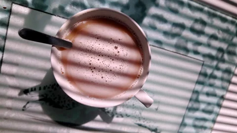 Morning Sunlight and Shadow Patterns Dance Across Swirling Hot Coffee Stock Footage 337452140