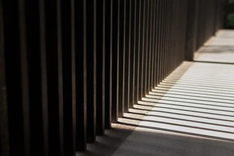 The morning sunlight shining through the rectangular pillars. parallel lines  Stock Photos