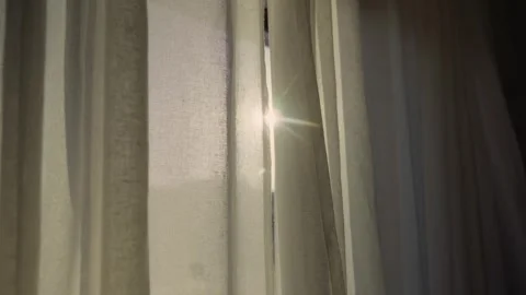 Morning sunlight streaming through sheer window curtains Stock Footage 339885881