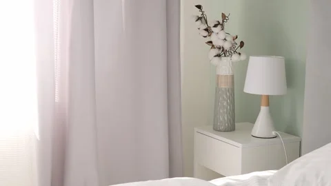 Morning sunlight streaming through the window onto the bed in the bedroom. Soft Stock Footage 274135112