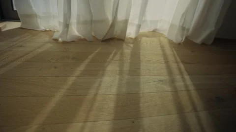 Morning sunlight streaming through a window curtain 库存影片 339886104