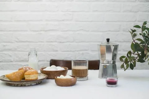 Morning table for breakfast. Two glasses of coffee, cottage cheese, eggs, donuts Stock Photos
