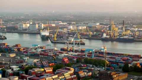 Morning Time-Lapse of Multicolored Box Stacks and Working Cranes at River Stock Footage 344015586