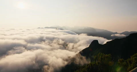 Morning timelapse of clouds rolling across mountain peaks and valleys Stock Footage 331223811