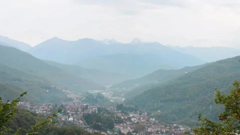 Morning timelapse in the mountains, with a view of the settlement. Stock Footage 221300172