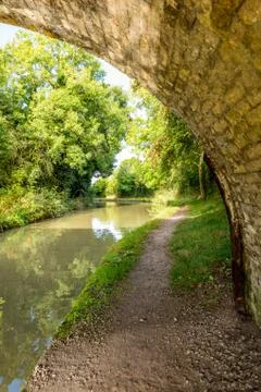 Morning view empty path under bridge along canal in England Stock-Fotos