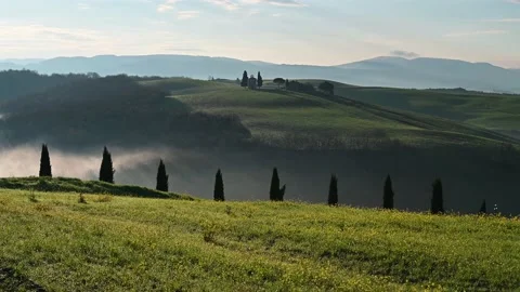 Morning view of the green spring fields in Tuscany and a small chapel Stock Footage 131840324