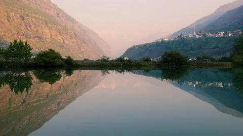 Morning view of Sissue lake with reflection of snow capped mountains Stock Footage 211815955