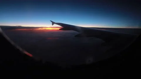 Morning view of the sunrise through the window during the airplane flight. The Stock Footage 221044005