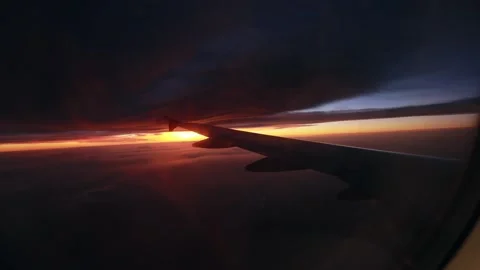 Morning view of the sunrise through the window during the airplane flight. The Stock Footage 221044553