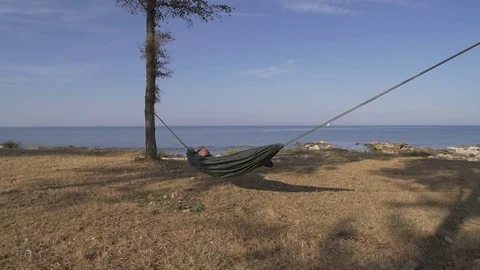Morning wake up in the hammock on the beach Stock Footage