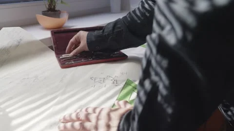 Morning Window Light Casting Shadow on Architect Sketching Blueprint Plan Stock Footage 341926685