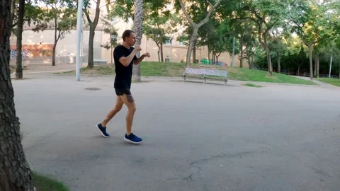 Morning workout. Muay thai box training in the park. Young man is running and Stock Footage 137781953