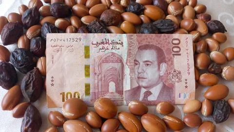 Moroccan 100 dirham banknote over Argan seeds Stock Photos